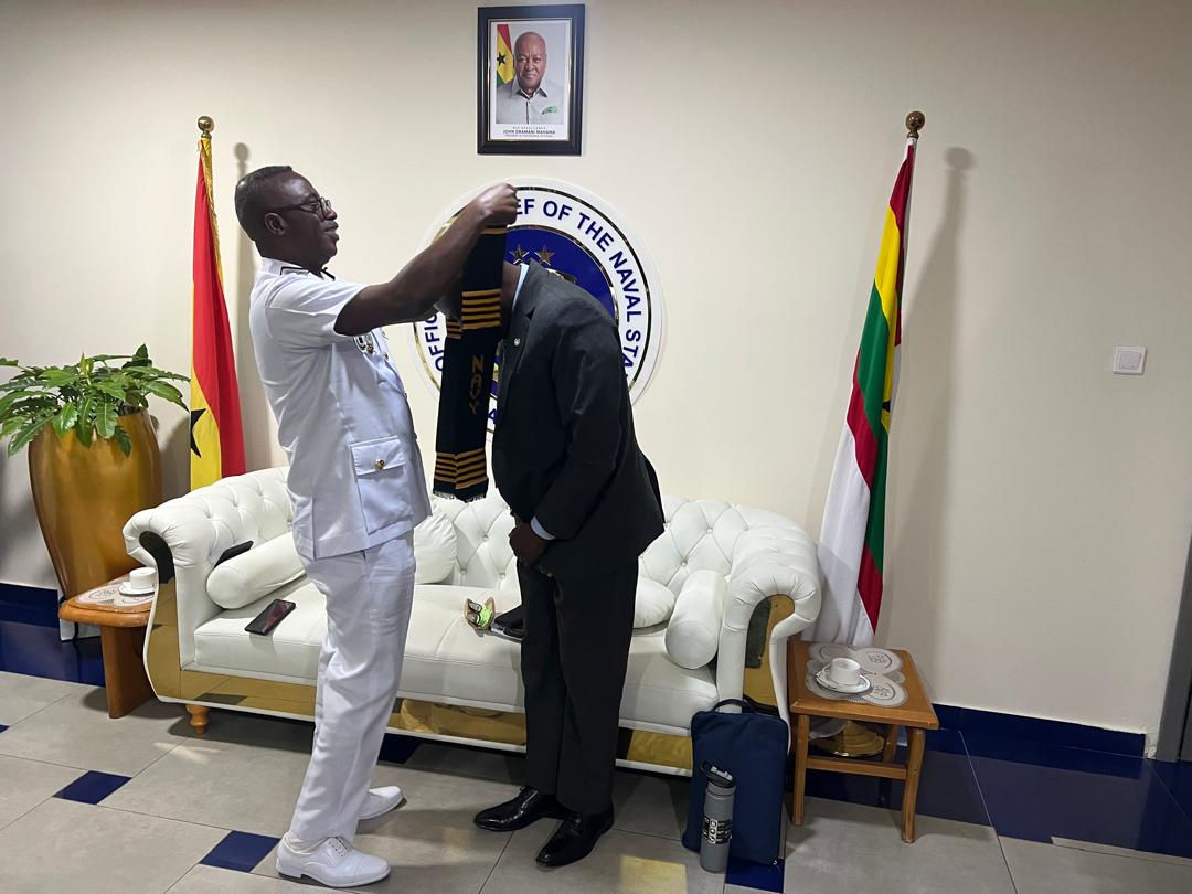 Chief of the Naval Staff, Ben Baba Abdul putting a sash on Prof. Mattah